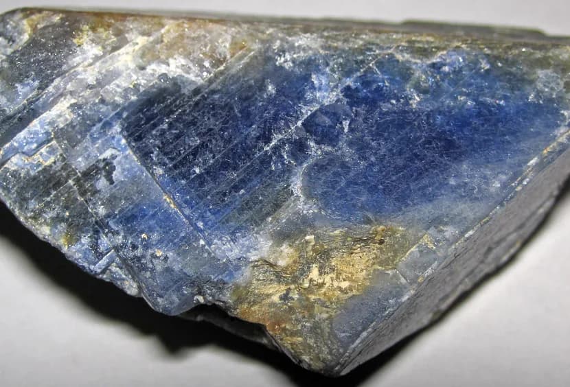 A natural blue sapphire crystal in its host rock.